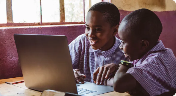 Students learning around a laptop
