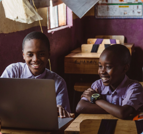 Students learning together around a laptop